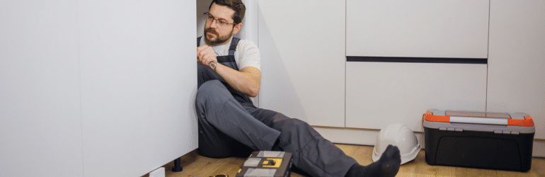workman at home Kitchen Cabinet Repair And Maintenance In Apartment