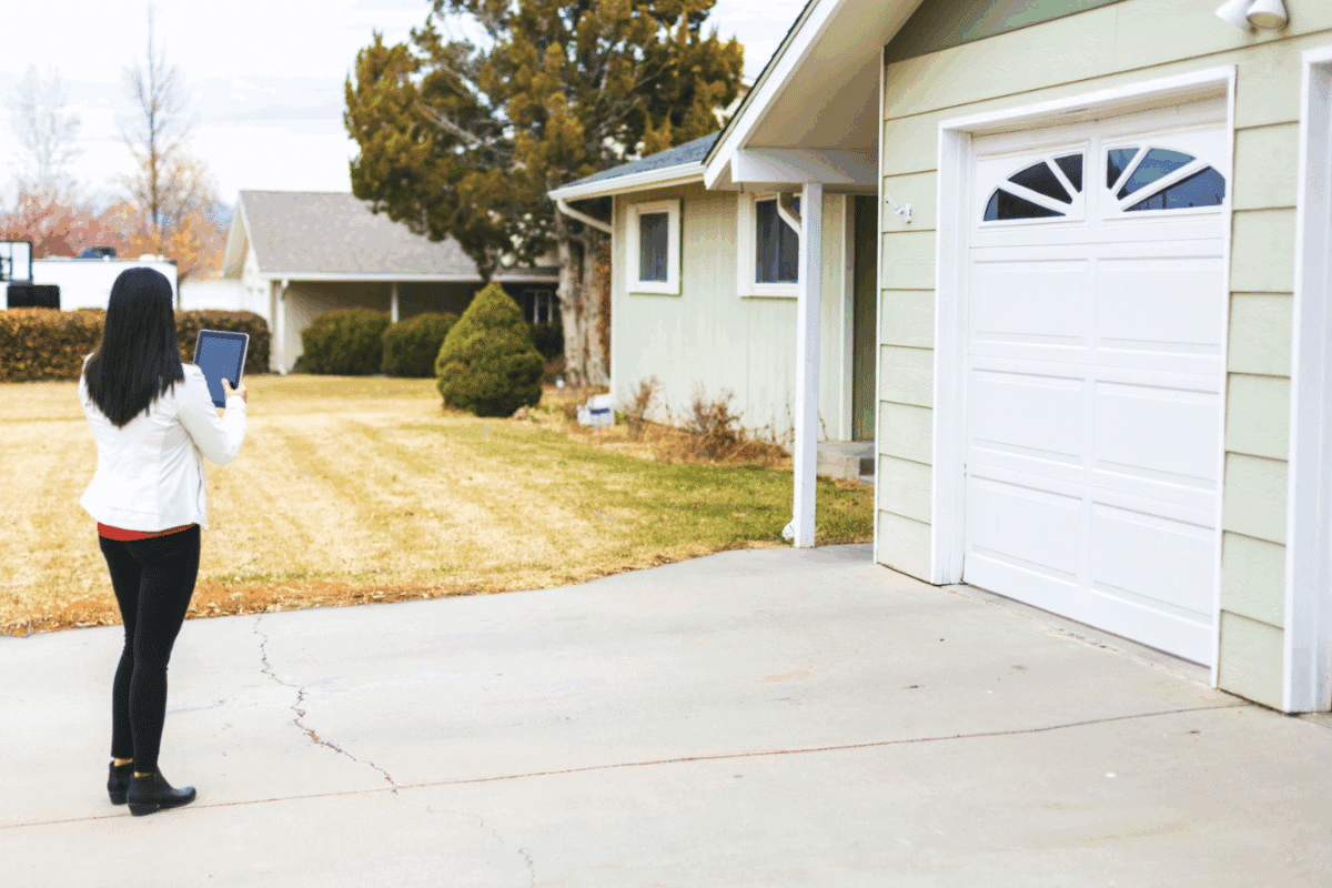 Young Adult Millennial Female Appraiser Measuring Home Features and Assessing Value in Western Colorado